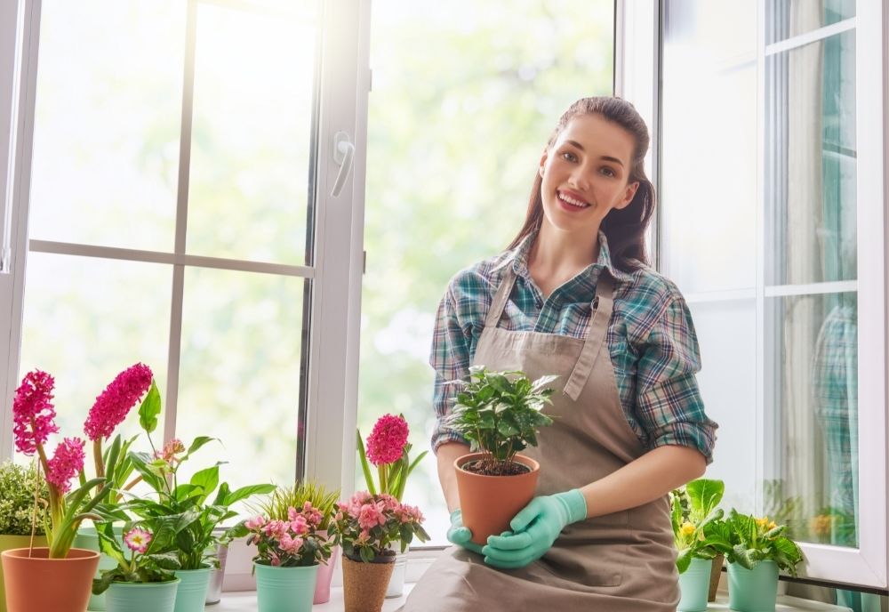 woman-holding-clay-pots-with-plants